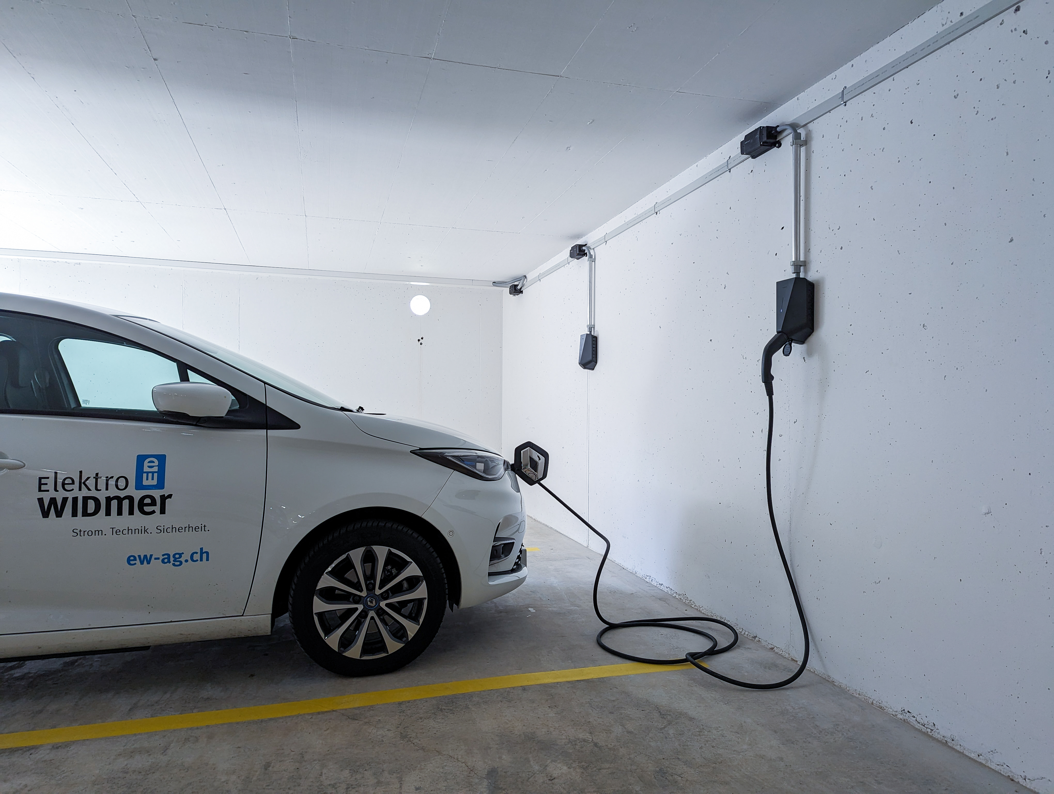 Auto von Elektro Widmer am Laden bei einer Ladestation in einer Tiefgarage